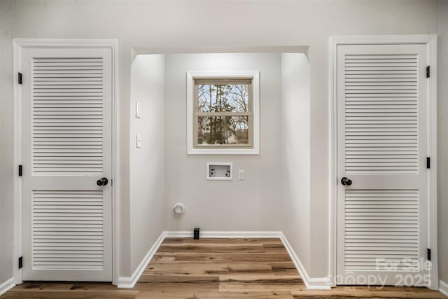 laundry room featuring hookup for a washing machine, baseboards, and wood finished floors