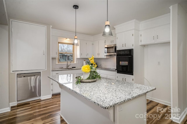 kitchen with decorative backsplash, white cabinets, dark wood-style floors, black appliances, and a sink