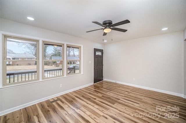 empty room with a ceiling fan, recessed lighting, baseboards, and wood finished floors