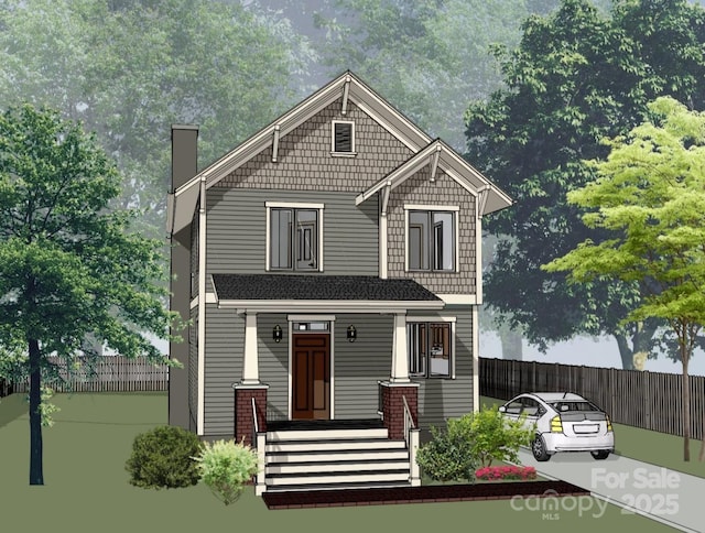 craftsman-style home with fence