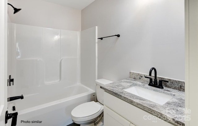 full bathroom with bathing tub / shower combination, vanity, and toilet