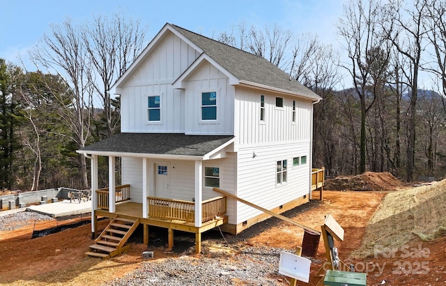 view of front of house with a shingled roof, crawl space, and board and batten siding