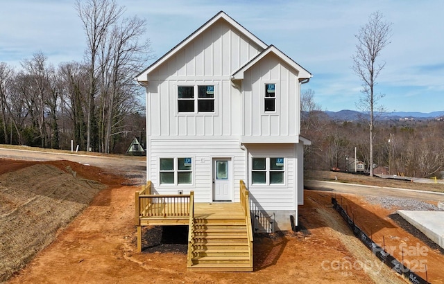 view of front of home featuring board and batten siding and a wooden deck