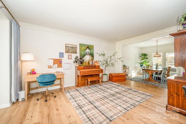 office area featuring baseboards, wood finished floors, and crown molding