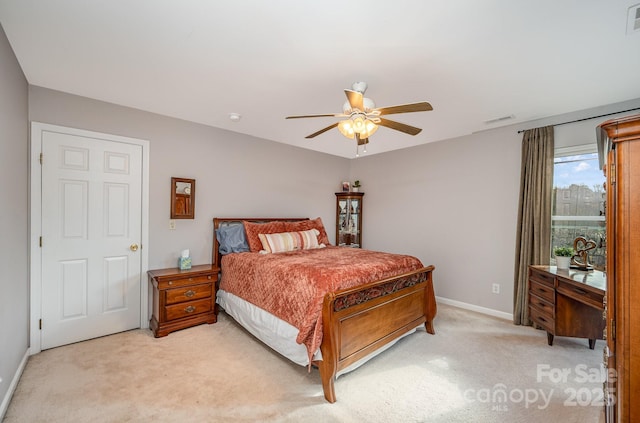 bedroom with baseboards, a ceiling fan, visible vents, and light colored carpet