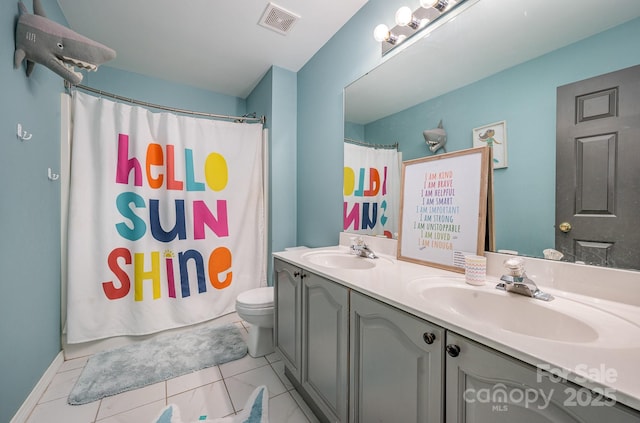 bathroom with visible vents, a sink, toilet, and double vanity