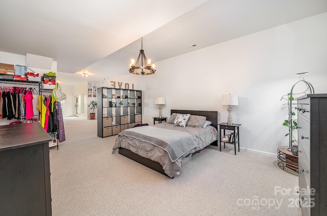 carpeted bedroom with a chandelier and baseboards