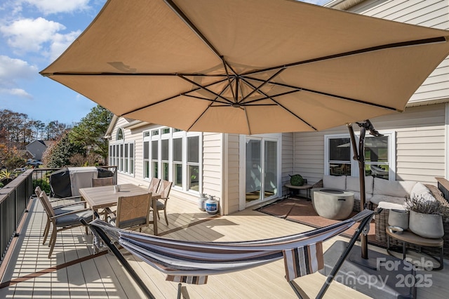 wooden terrace featuring outdoor dining space