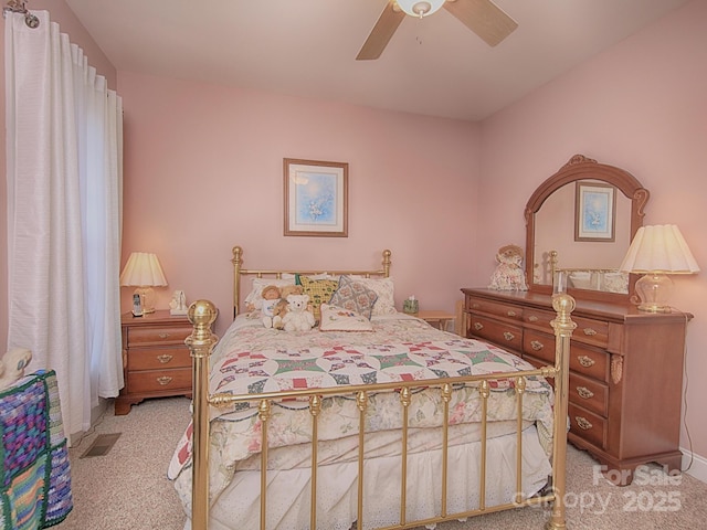 bedroom featuring light carpet, ceiling fan, and visible vents