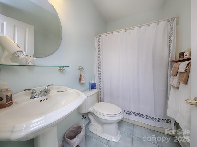 full bath with a sink, tile patterned flooring, toilet, and a shower with curtain