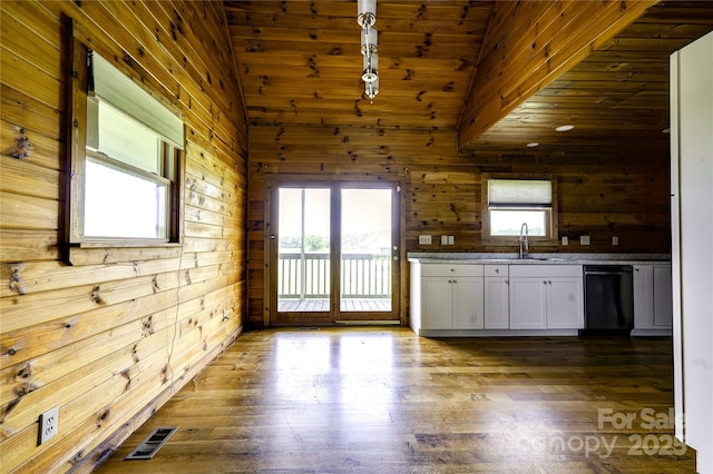 3640 Oak Haven Ln, Shelby, NC 28150 - kitchen with dishwasher, lofted ceiling, wood walls, white cabinetry, and dark wood-type flooring