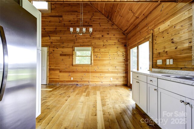 3640 Oak Haven Ln, Shelby, NC 28150 - unfurnished dining area with vaulted ceiling, wood ceiling, wooden walls, light wood-type flooring, and a chandelier