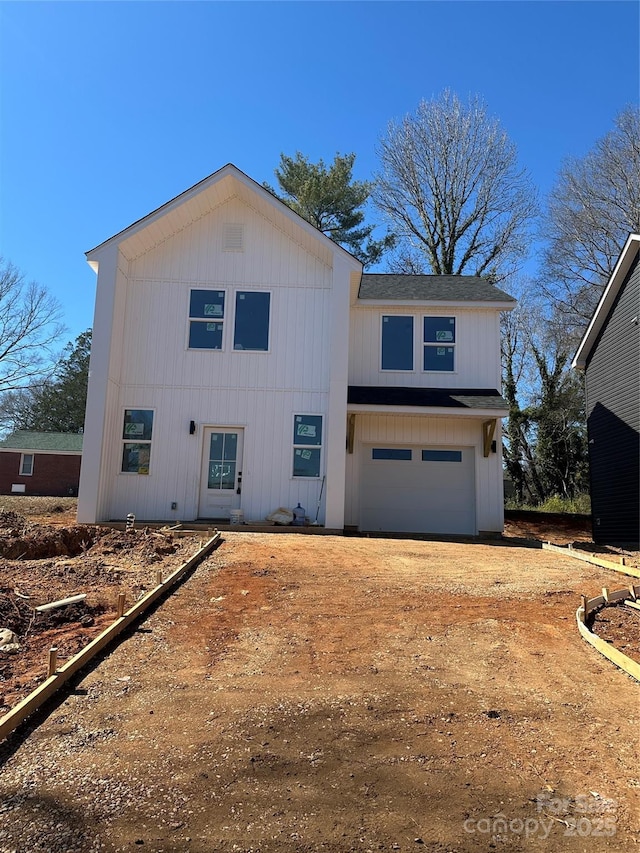 modern farmhouse style home with driveway and an attached garage