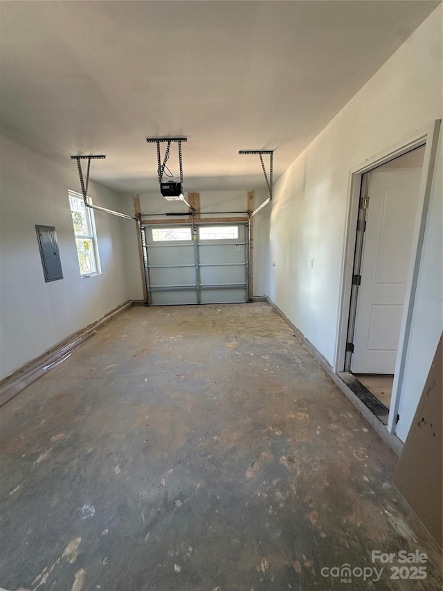 garage with electric panel and a garage door opener