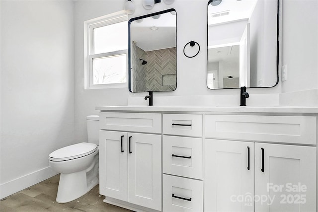 full bathroom with wood finished floors, visible vents, baseboards, double vanity, and toilet