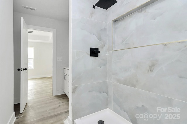 full bath featuring visible vents, a stall shower, vanity, and wood finished floors