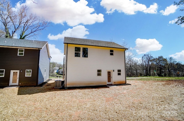 rear view of property with cooling unit