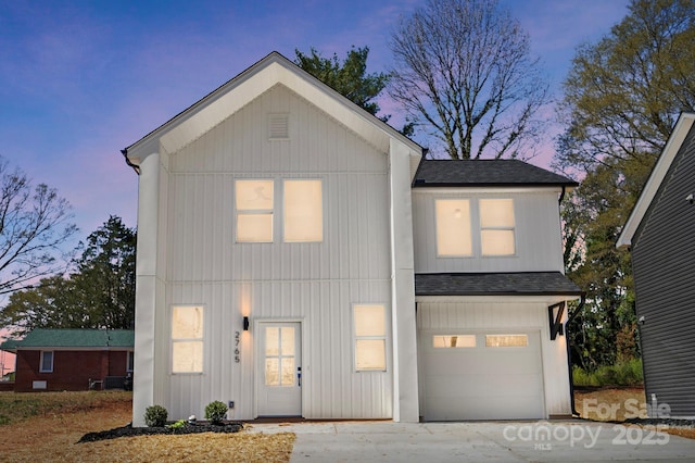 view of front facade with driveway, a garage, board and batten siding, and roof with shingles