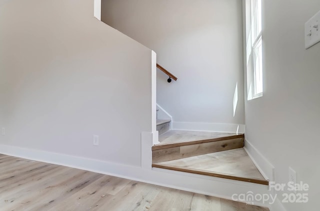 stairs featuring baseboards and wood finished floors