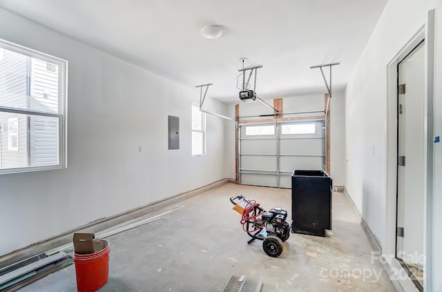 garage featuring baseboards, electric panel, and a garage door opener