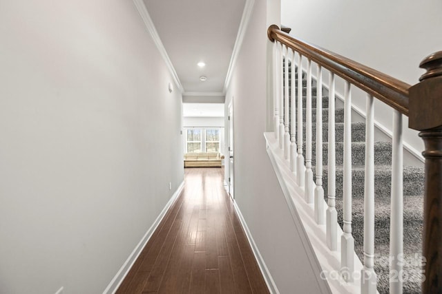 corridor with ornamental molding, recessed lighting, dark wood finished floors, and baseboards