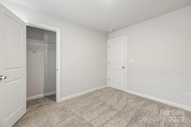 unfurnished bedroom with carpet, baseboards, and a closet