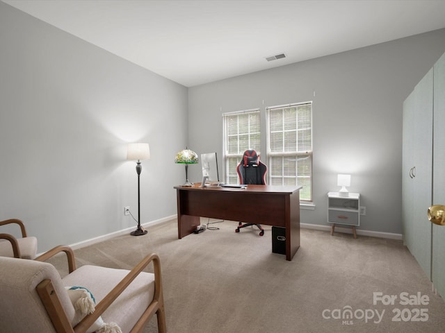 home office featuring visible vents, baseboards, and light carpet