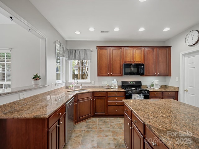 kitchen featuring recessed lighting, a sink, black appliances, and light stone countertops