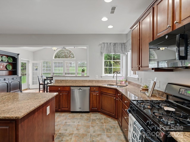 kitchen with visible vents, black microwave, stainless steel dishwasher, a sink, and range with gas stovetop