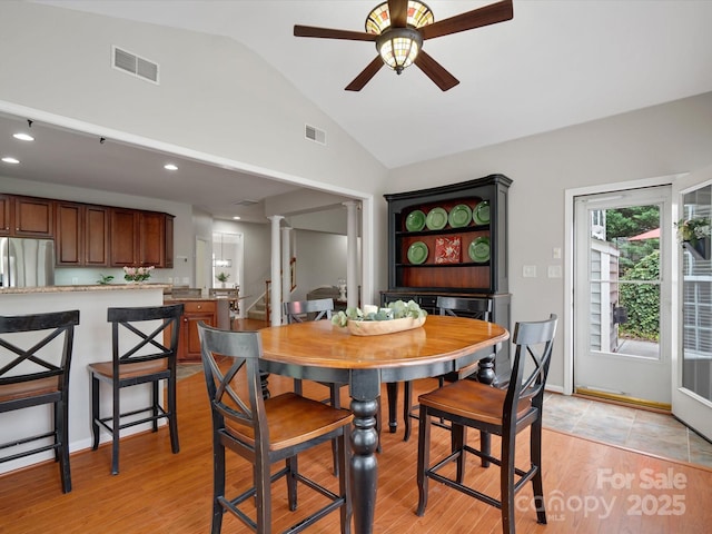 dining space with visible vents, a ceiling fan, ornate columns, and lofted ceiling