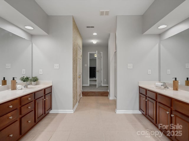 full bathroom with vanity, baseboards, and visible vents