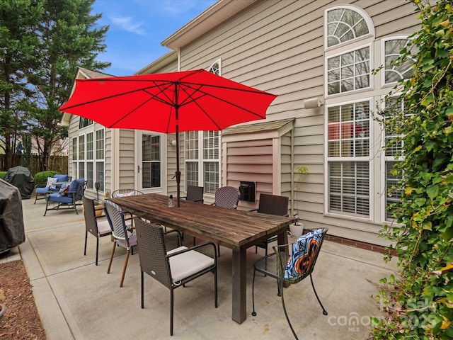 view of patio featuring fence and outdoor dining space