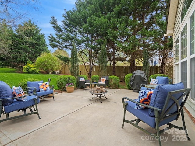 view of patio with a fenced backyard and an outdoor living space with a fire pit