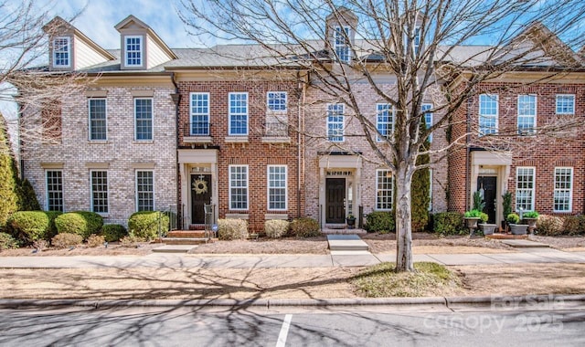 view of property featuring brick siding