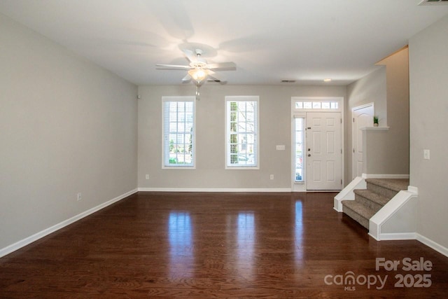 foyer entrance featuring visible vents, baseboards, ceiling fan, and wood finished floors