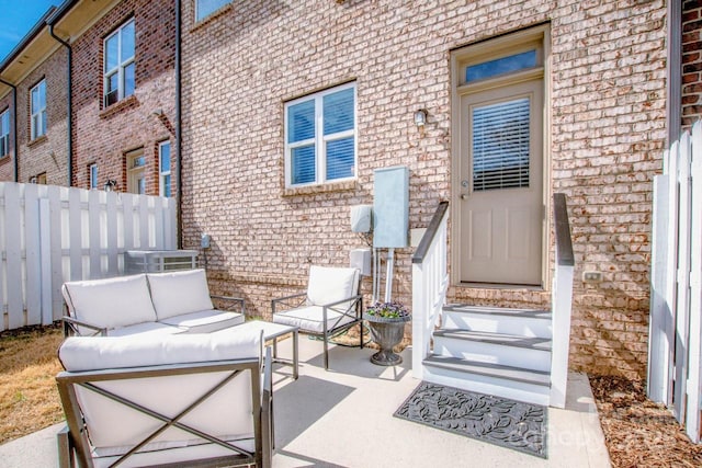 view of patio / terrace featuring outdoor lounge area, fence, and cooling unit