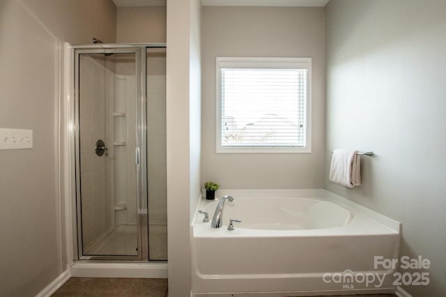 full bath with tile patterned floors, a shower stall, and a bath