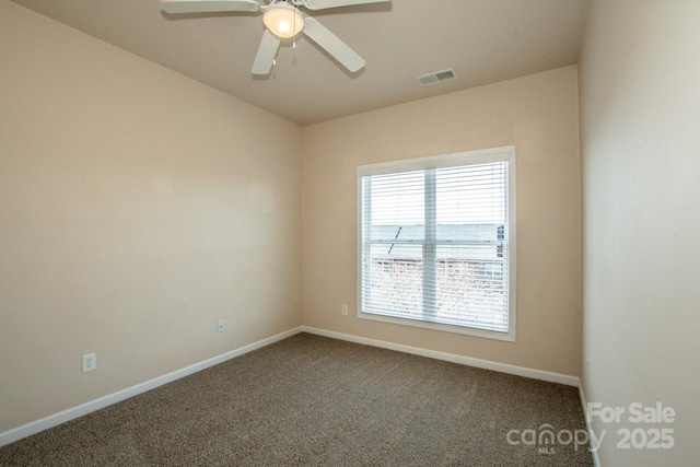 unfurnished room with a ceiling fan, carpet flooring, visible vents, and baseboards