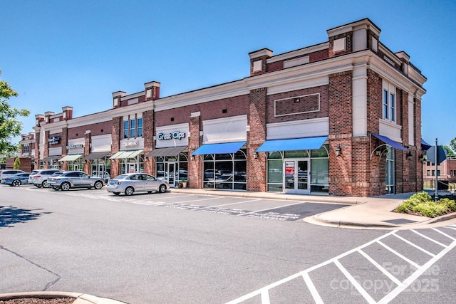 view of property featuring uncovered parking