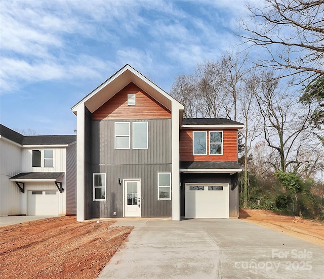 view of front facade with concrete driveway and an attached garage