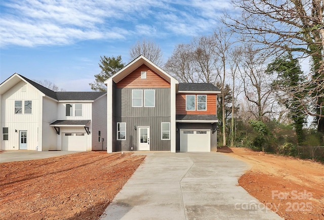 view of front of home featuring concrete driveway, an attached garage, and roof with shingles