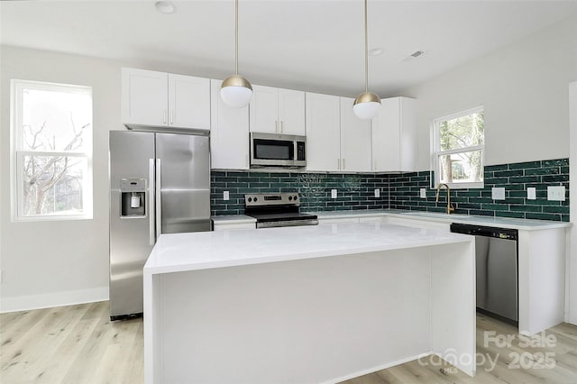 kitchen with white cabinetry, visible vents, appliances with stainless steel finishes, and a sink