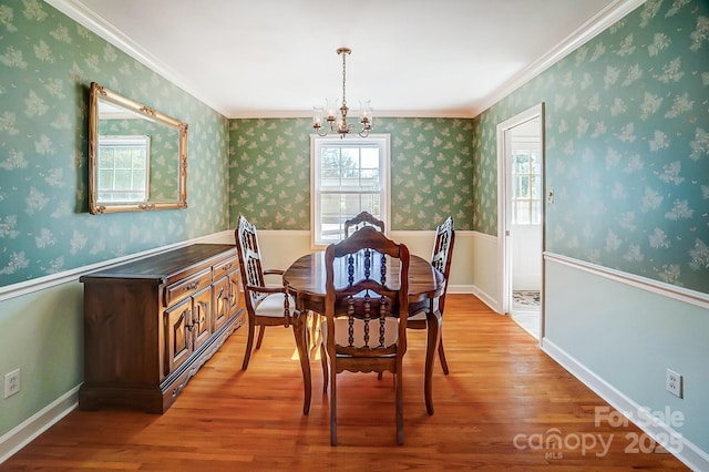 dining room featuring light wood-style floors, a chandelier, and wallpapered walls