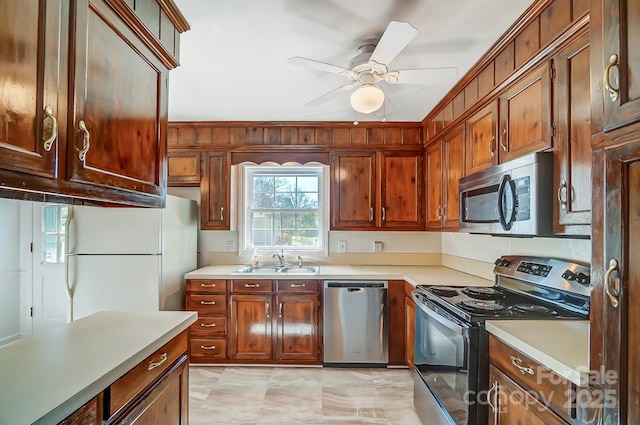 kitchen featuring a sink, light countertops, ceiling fan, and stainless steel appliances