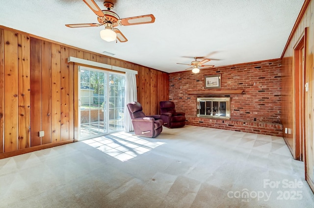 unfurnished room featuring visible vents, a textured ceiling, carpet, and a ceiling fan