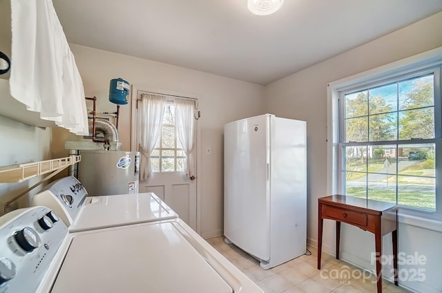 laundry room with baseboards, laundry area, light tile patterned flooring, water heater, and washer and clothes dryer