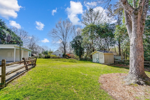 view of yard with a fenced backyard, a storage unit, and an outdoor structure