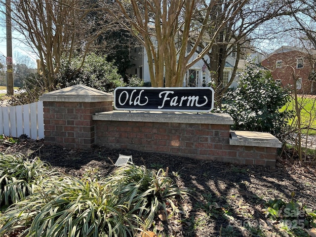 community sign featuring fence