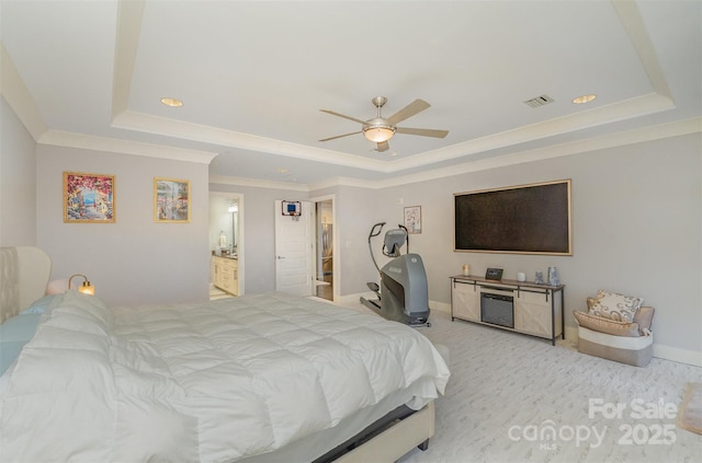 bedroom featuring light carpet, visible vents, a tray ceiling, and crown molding