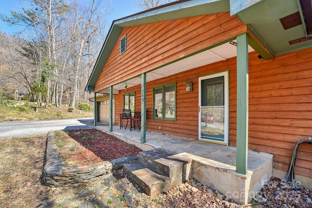 exterior space with a garage, driveway, and a porch